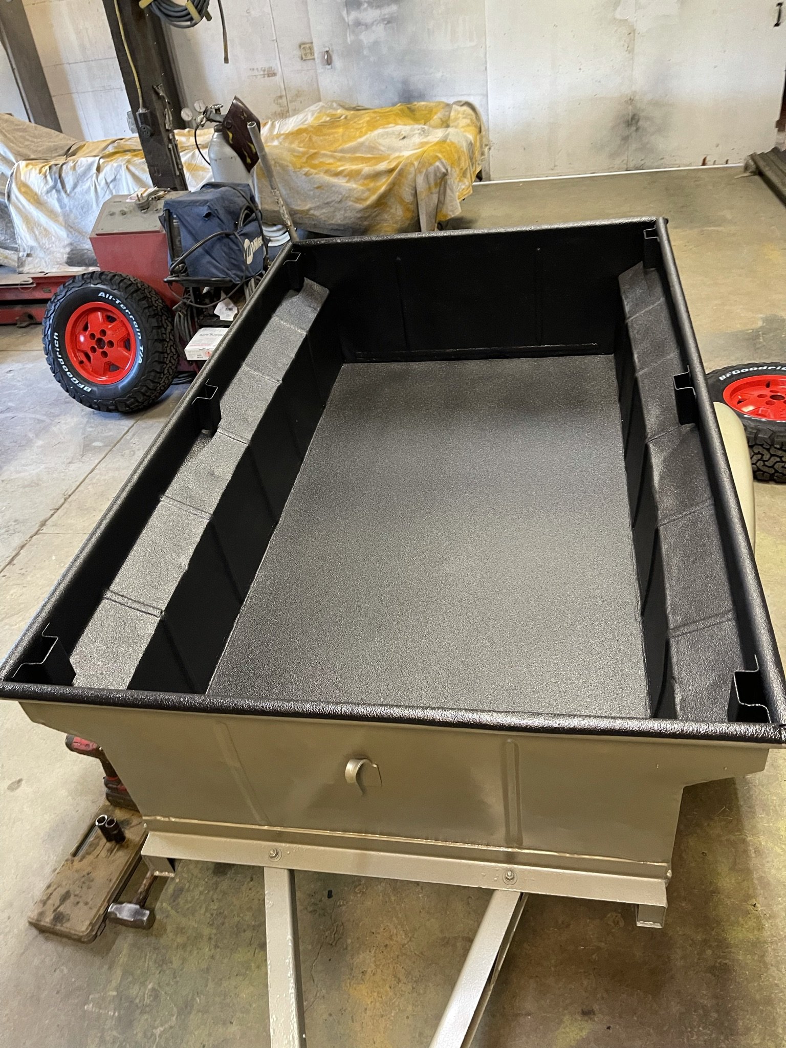 New thicker gauge floor welded in and painted to with bedliner, while the exterior used leftover beige paint from the Jurassic Jeep.