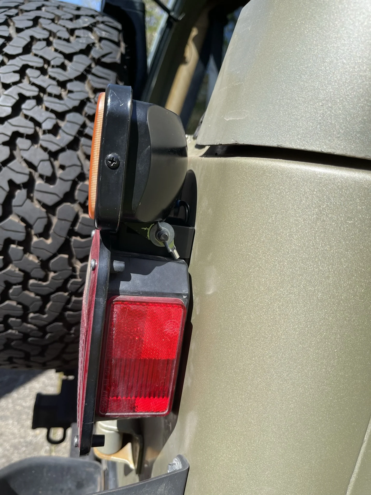 Nice and flush up to the body, just above the rear light.