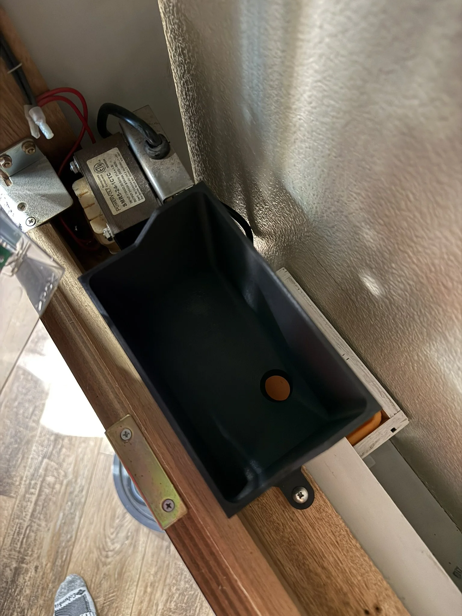 I designed and 3D printed this tray to collect the balls as they drop out of the machine, and then drop them into the drawer below. 