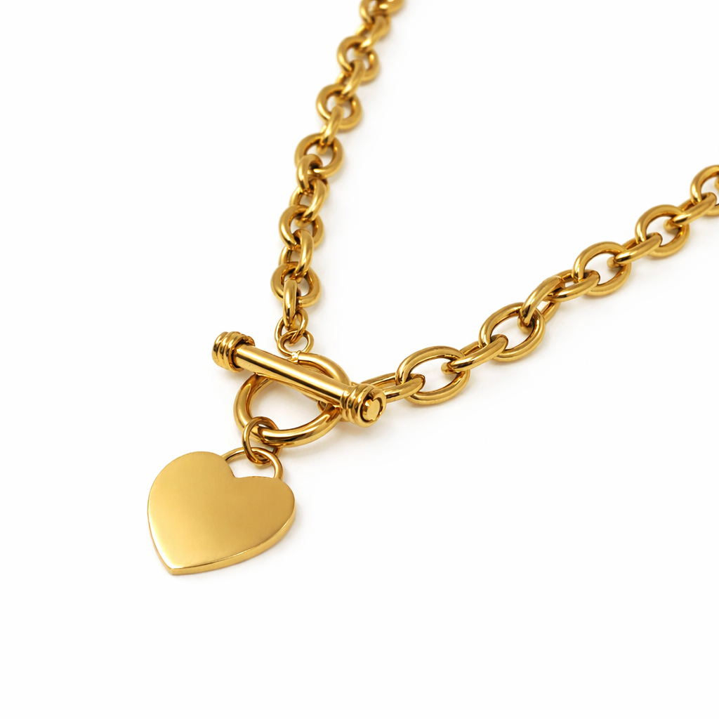 Gold chain necklace with a heart-shaped pendant and a toggle clasp.