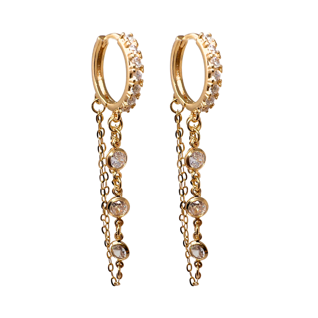 Gold hoop earrings with dangling chains and embedded clear gemstones.