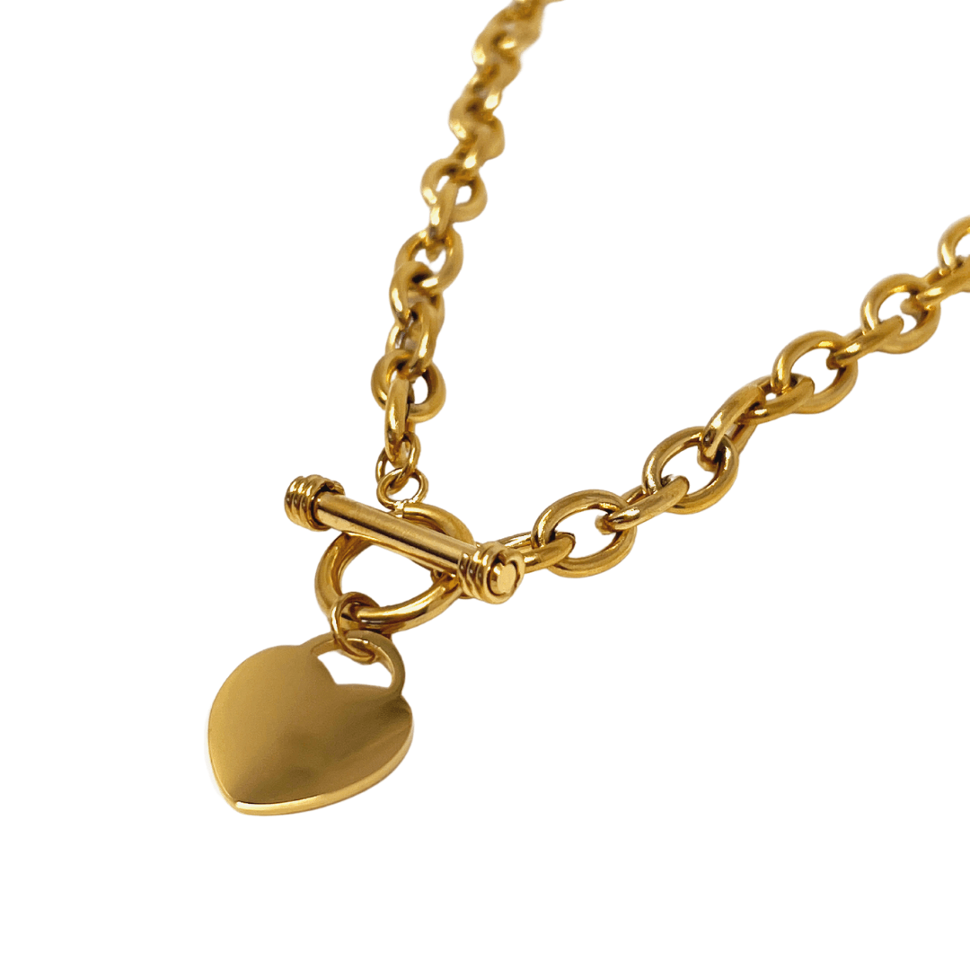 Gold chain necklace with a small heart-shaped pendant.