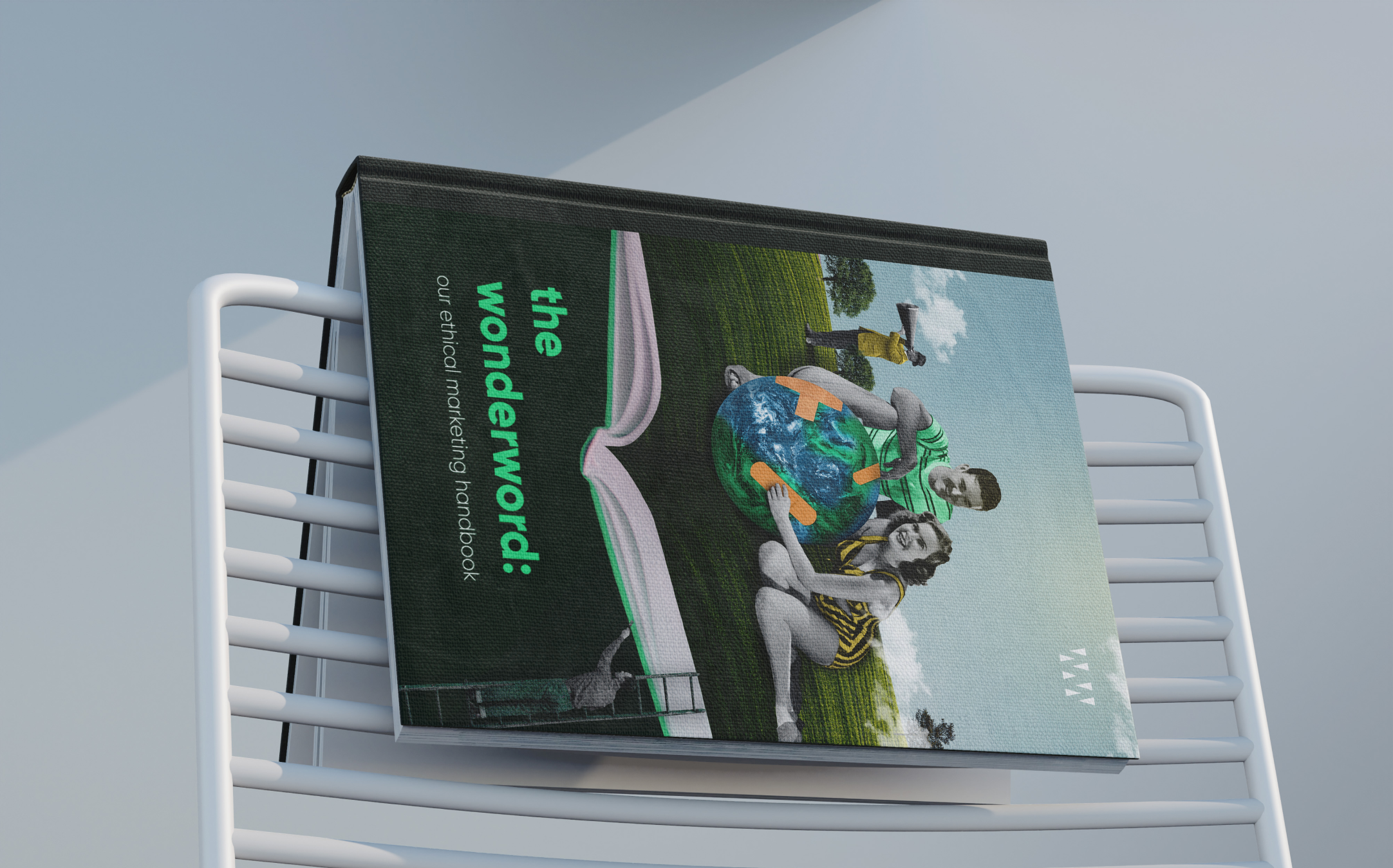 Book titled 'The Wonderword: Our Ethical Marketing Handbook' on a chair, featuring a retro-style cover with people holding a globe.
