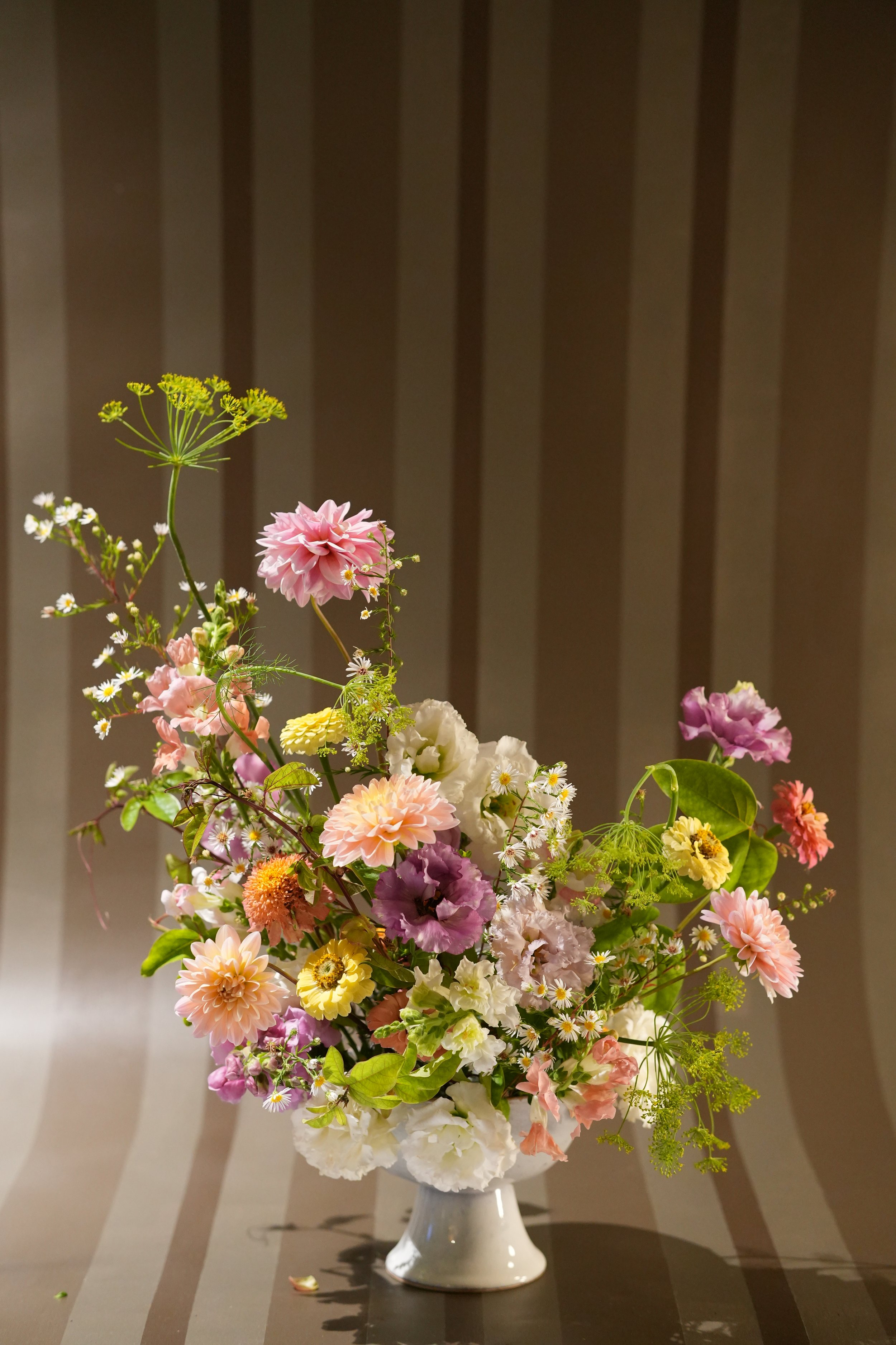 A garden-forward arrangement built around rooftop grown dahlias and delicate late-summer blooms.