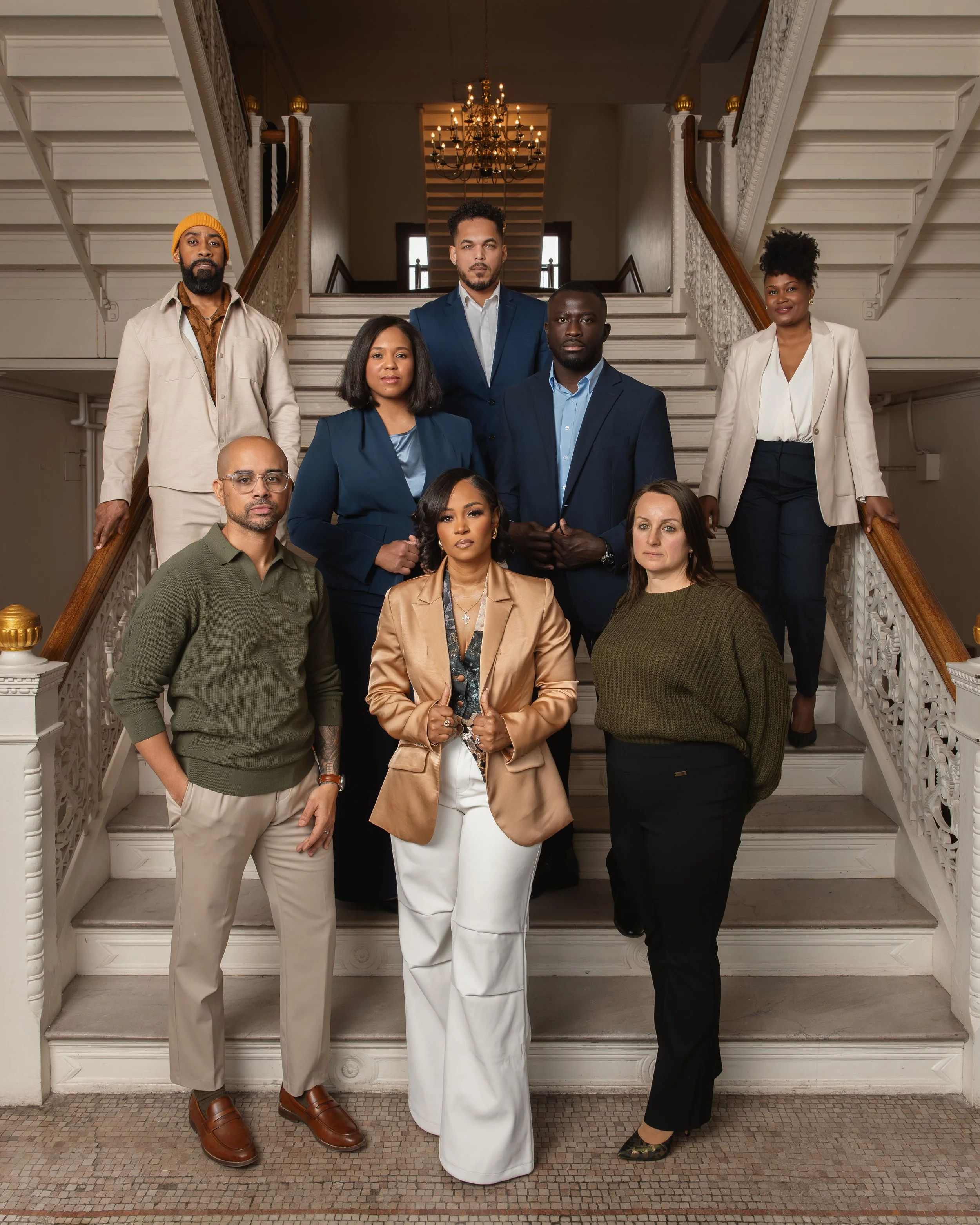 The Greater Brockton Young Professionals Freshman Class of 26' posing a inside the staircase of Brockton CIty Hall