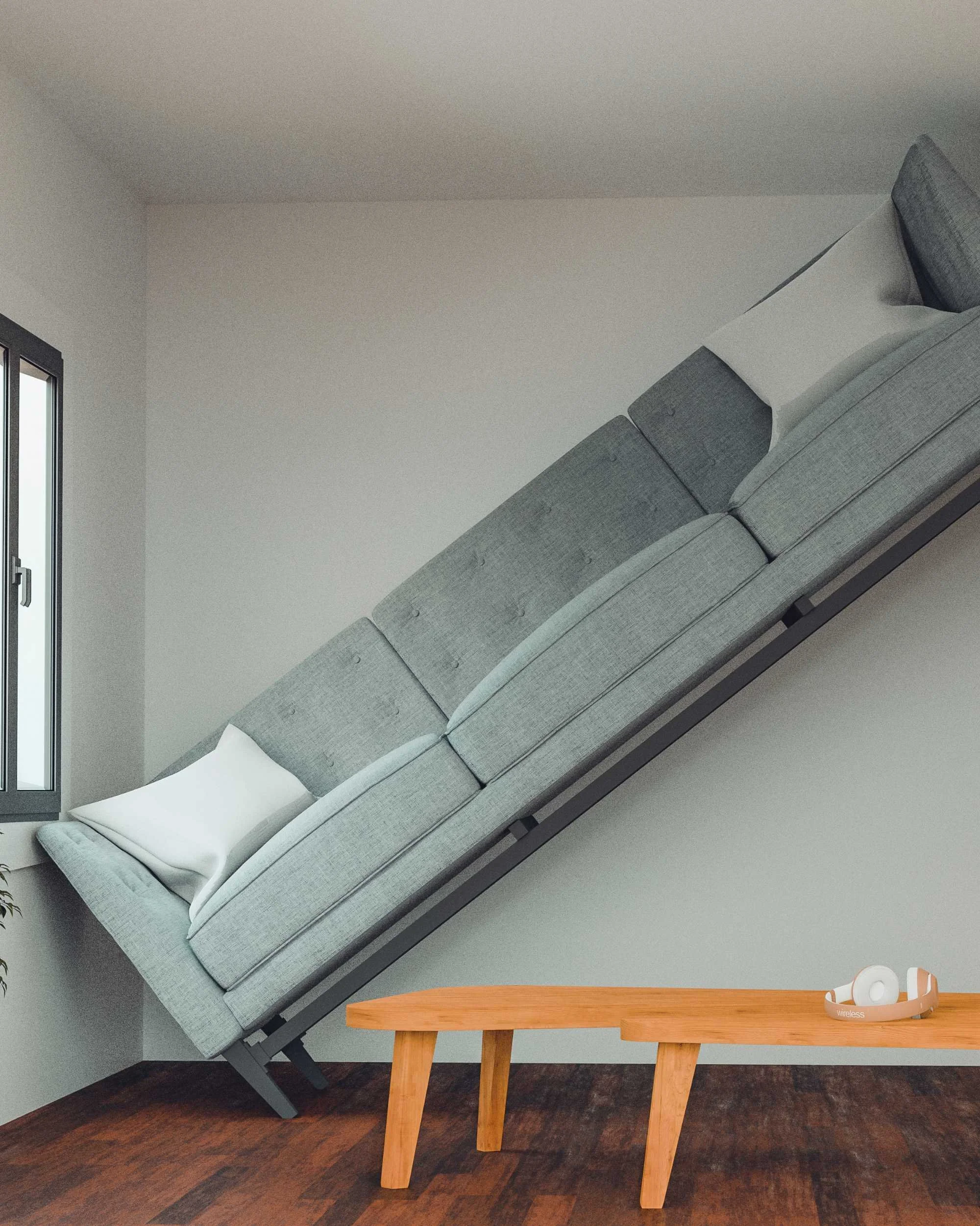 Modern interior with a tilted gray sofa on one wall, a wooden coffee table on a wooden floor, and white headphones on the table. A window with a partial view to the outside is on the left.