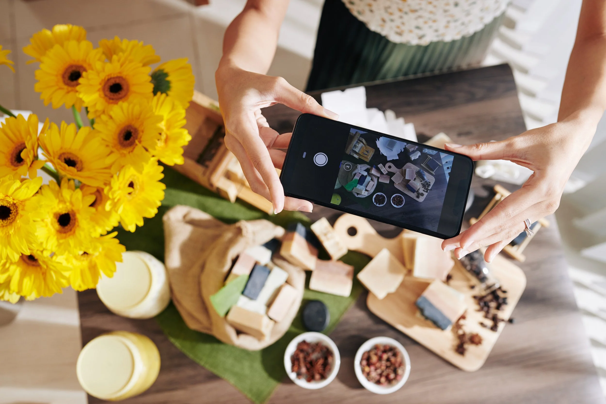 someone taking flat lay photo of a cheese spread