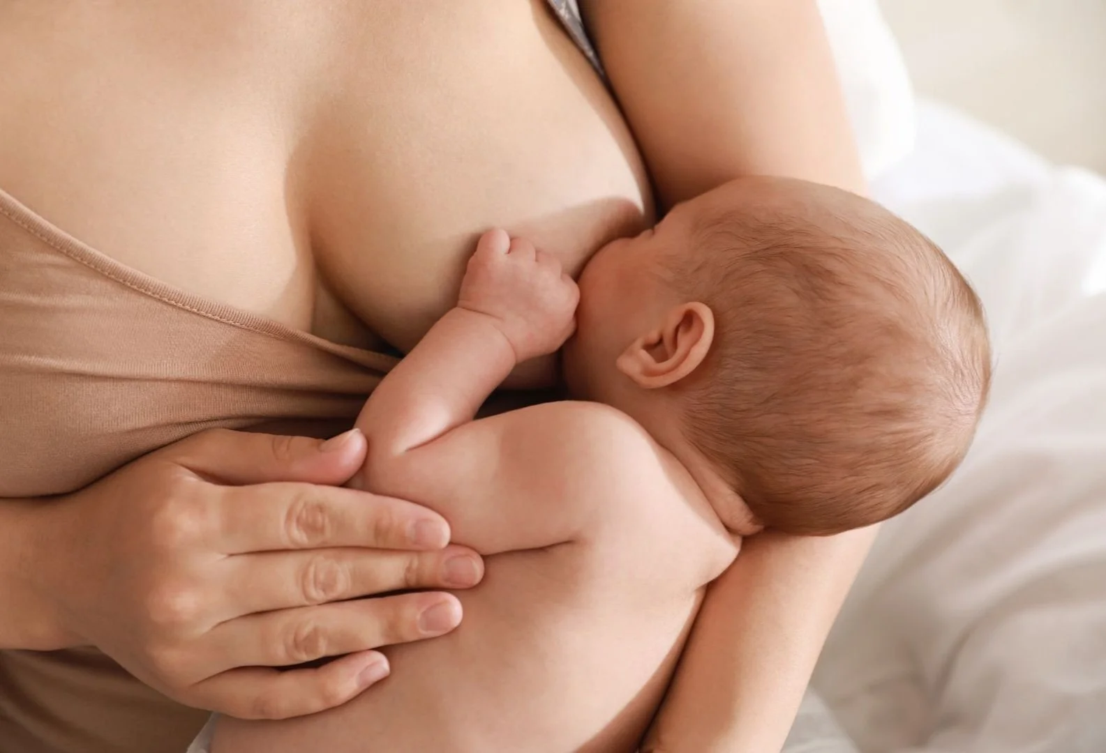 Mother breastfeeding infant in close-up view.