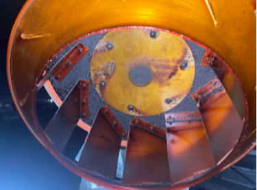 Before cleaning: grease-coated interior of a commercial exhaust fan