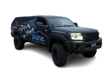 A black van with a graphic design on the side and the word 'shine' visible.