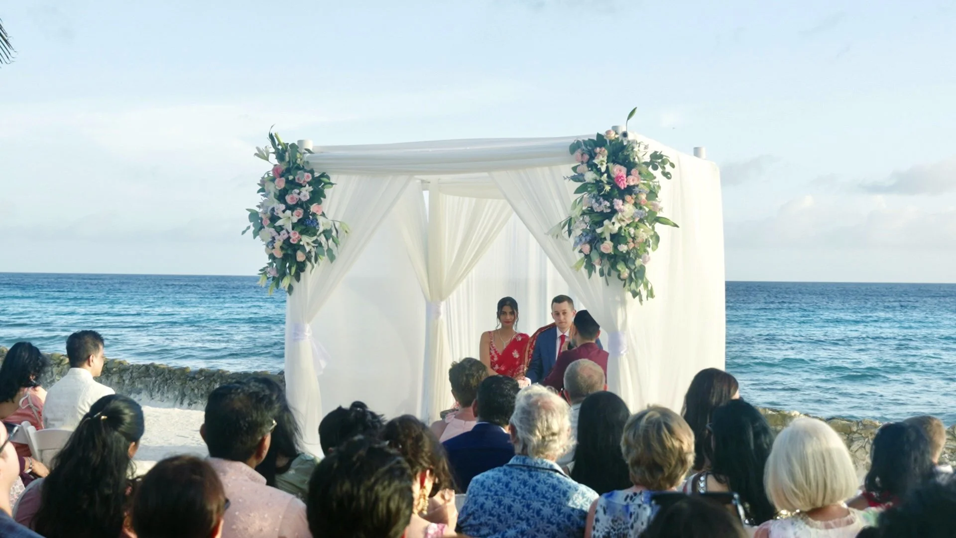 Aruba Hindu wedding vows under a floral canopy at an Aruba beach wedding on Renaissance Private Flamingo Island