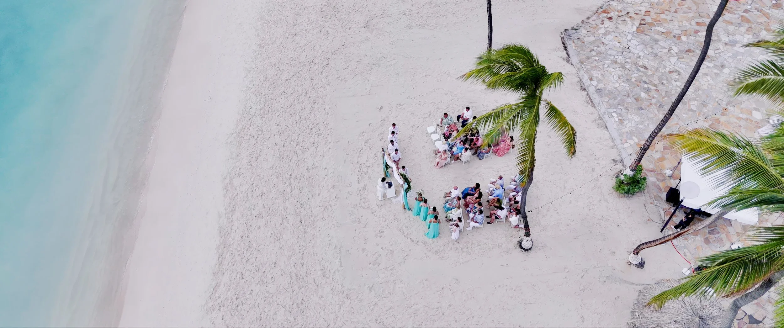 Aerial drone view of Gianna and Daniel's Aruba beach wedding ceremony at Holiday Inn Resort Aruba on Palm Beach