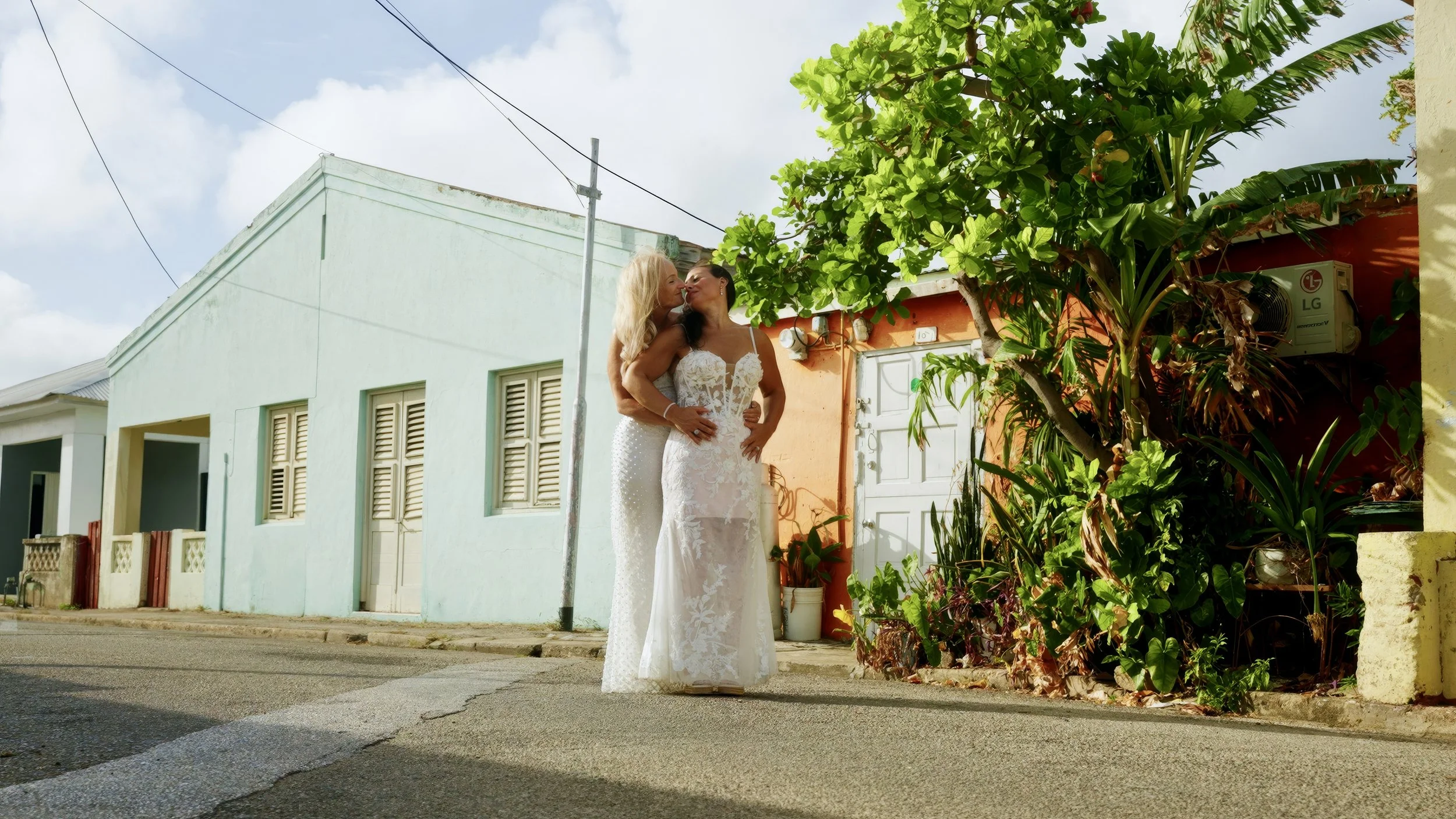 Two Aruba brides exploring Oranjestad, Aruba during an adventure session with Aruba wedding videographer Wedding Films by Mira