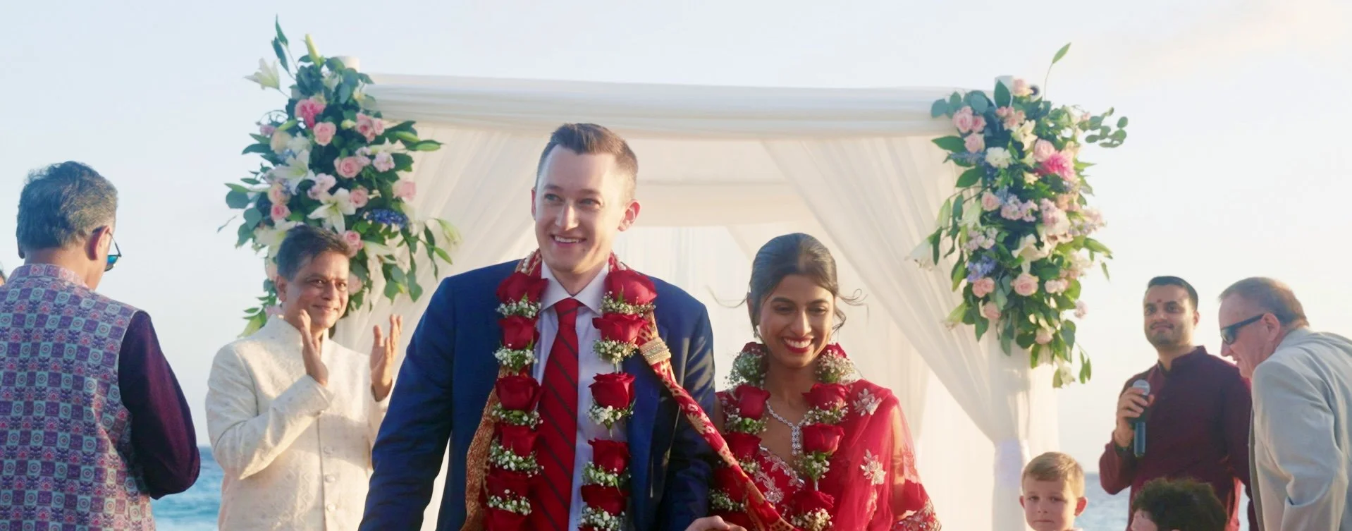 Aruba newlyweds walking down the aisle after their Hindu beach wedding on Renaissance Private Flamingo Island, Aruba