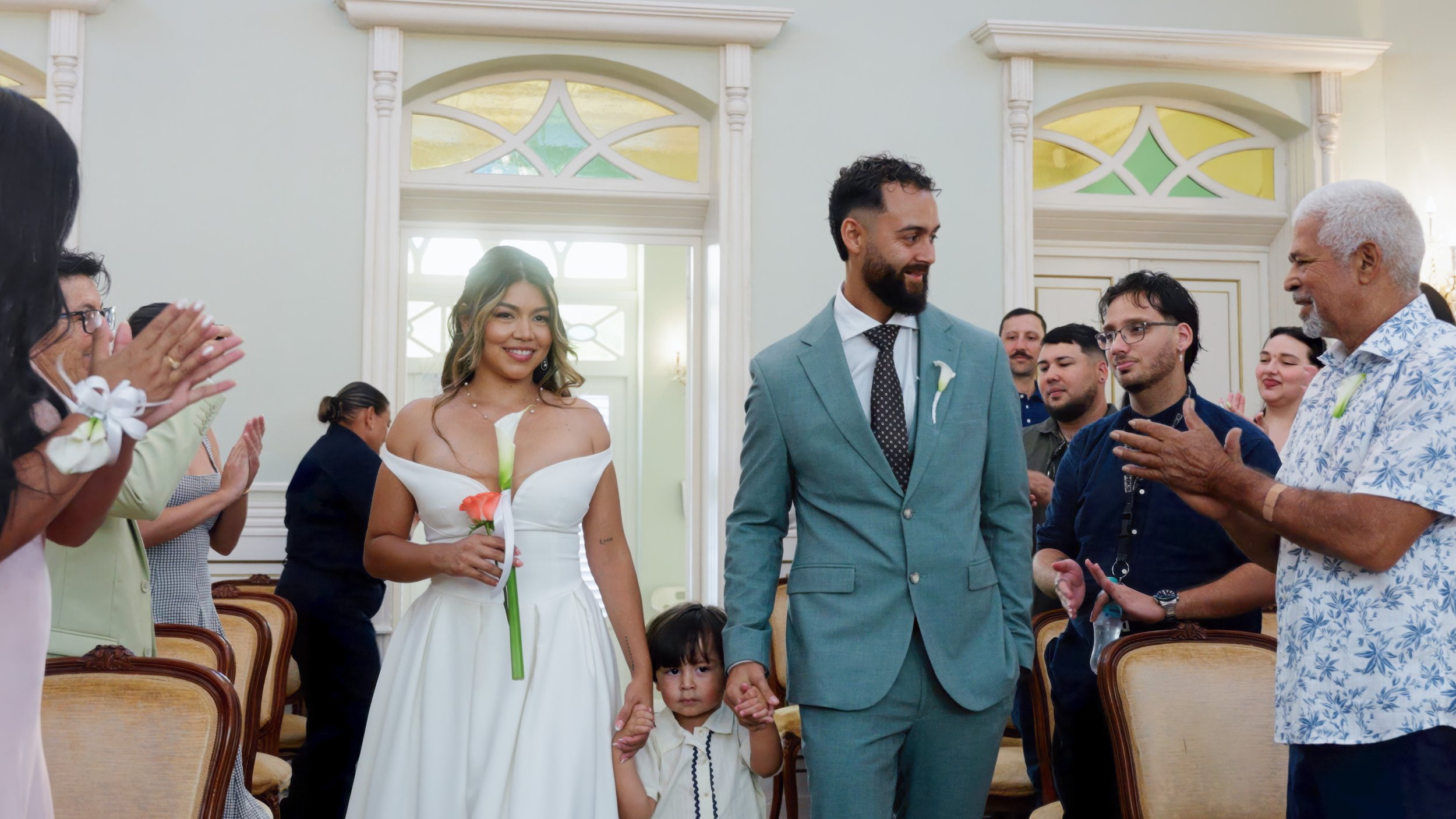 Bride and groom joyfully exit their beach ceremony on Surfside Beach, Aruba, destination wedding filmed by Wedding Films by Mira