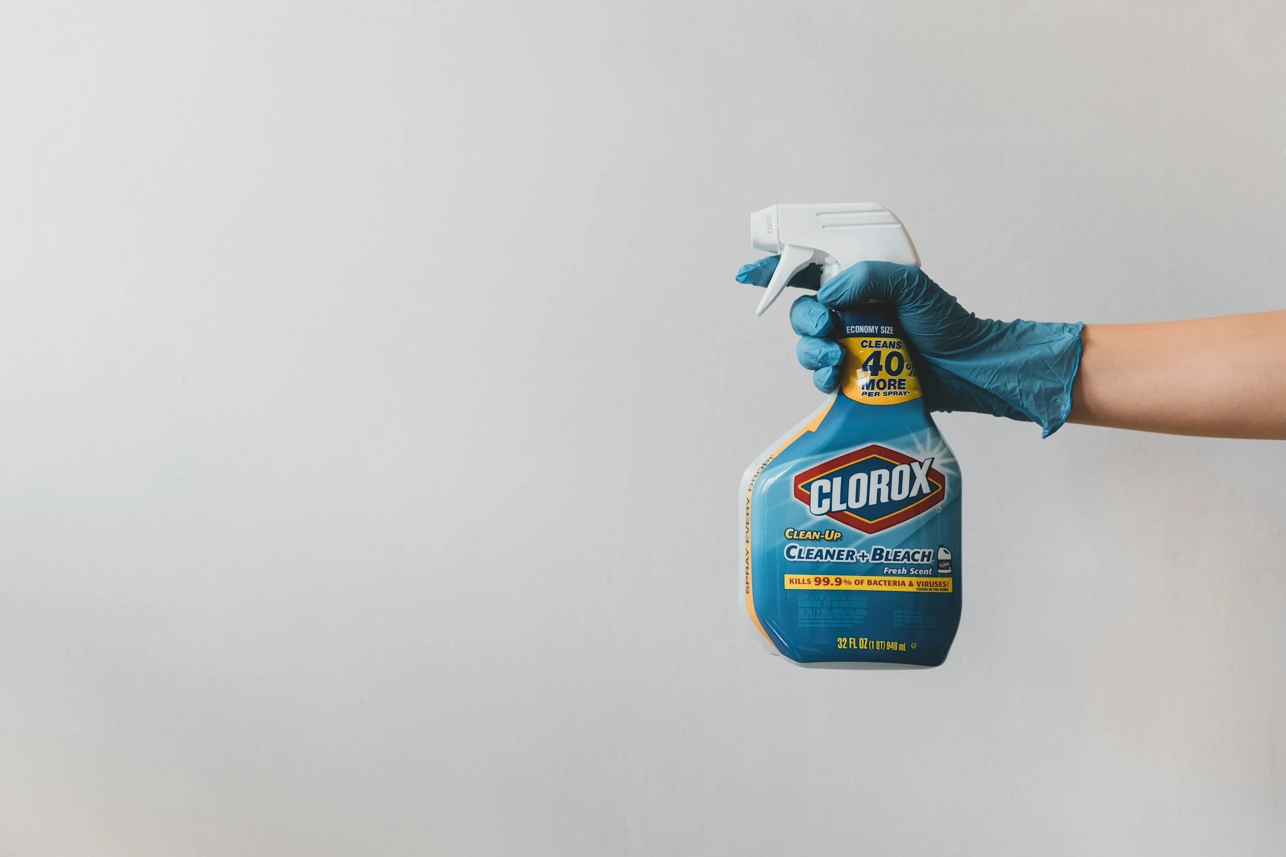 Hand holding a Clorox cleaning spray bottle.