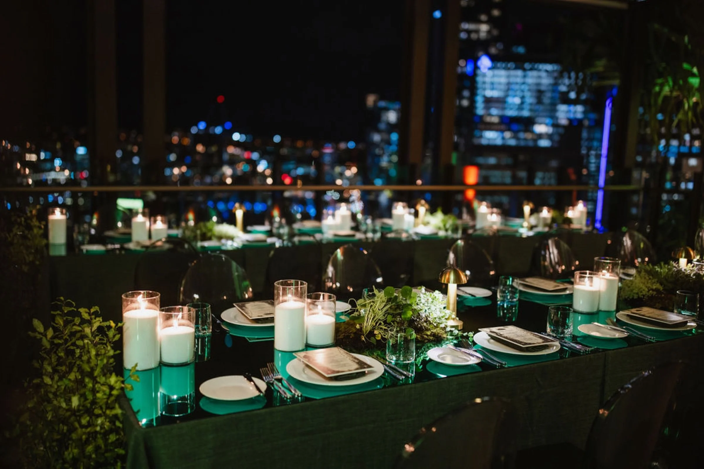 Rooftop dinner event styling with city skyline views