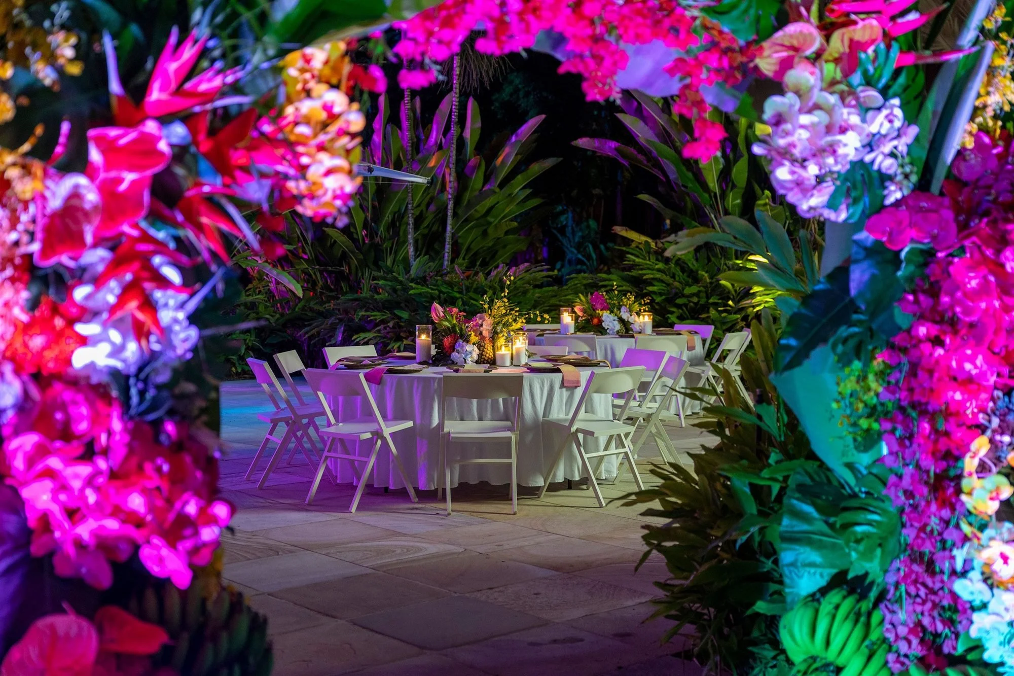 Colourful floral arch entrance on Hayman Island, framing an outdoor dining setup at a LinkedIn corporate event