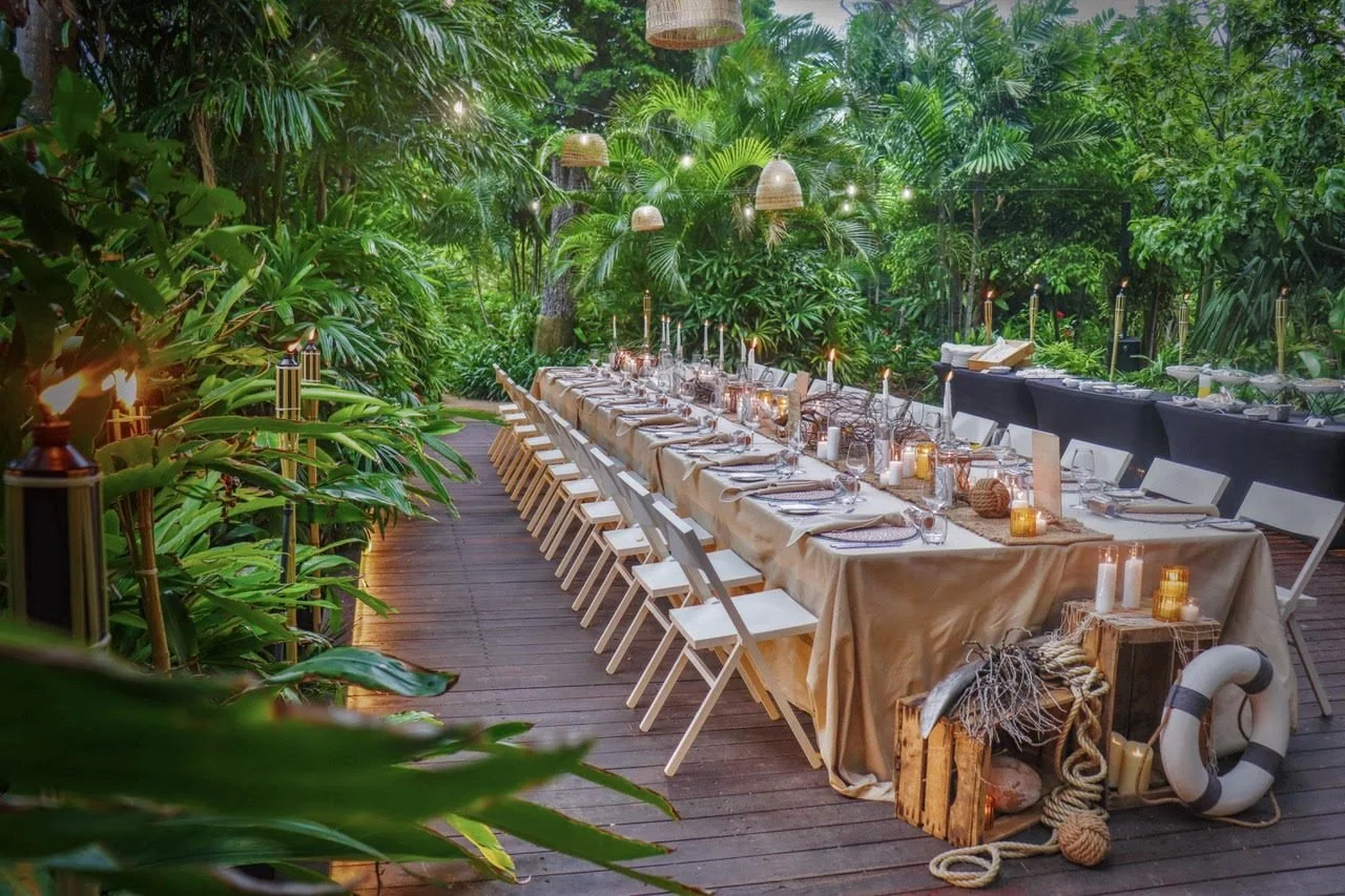 Rustic jungle boardwalk dinner setup with tiki torches and nautical styling on Hayman Island