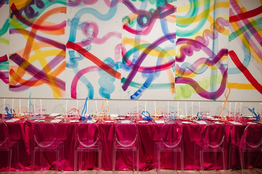 Corporate gala tablescape styled by Sapia Creative with a colourful ribbon installation backdrop