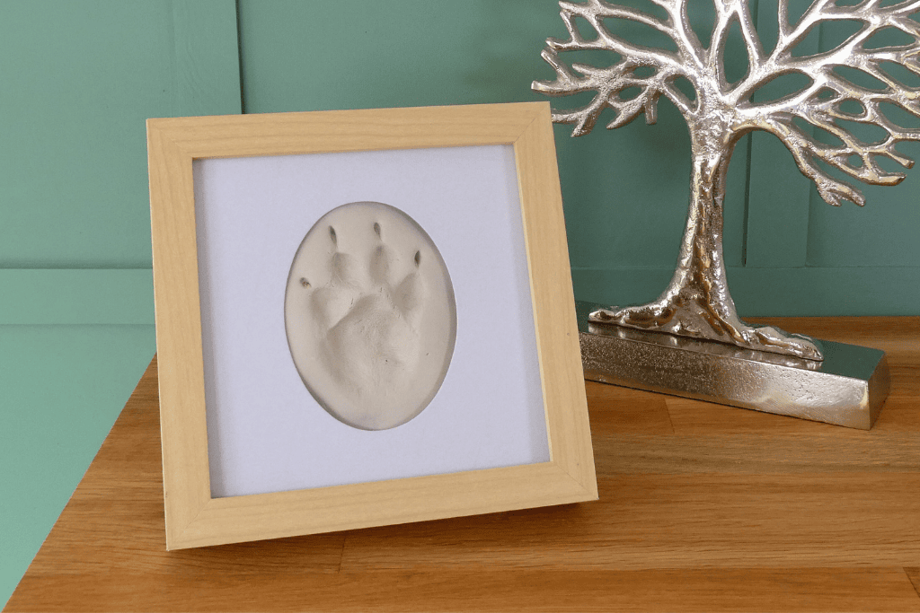 A carefully hand-prepared impression of your pet's paw, presented in a natural wooden frame with glass.
