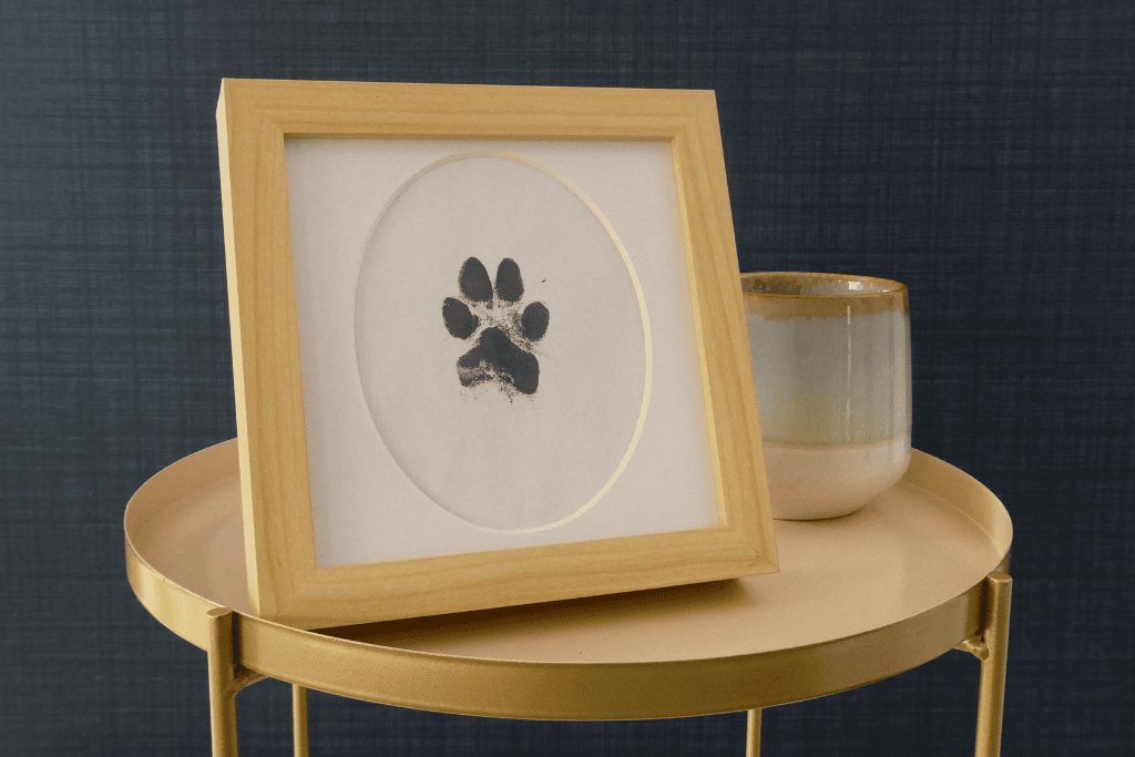 A unique ink print of your pet's paw or nose, presented in a natural wooden frame with glass
