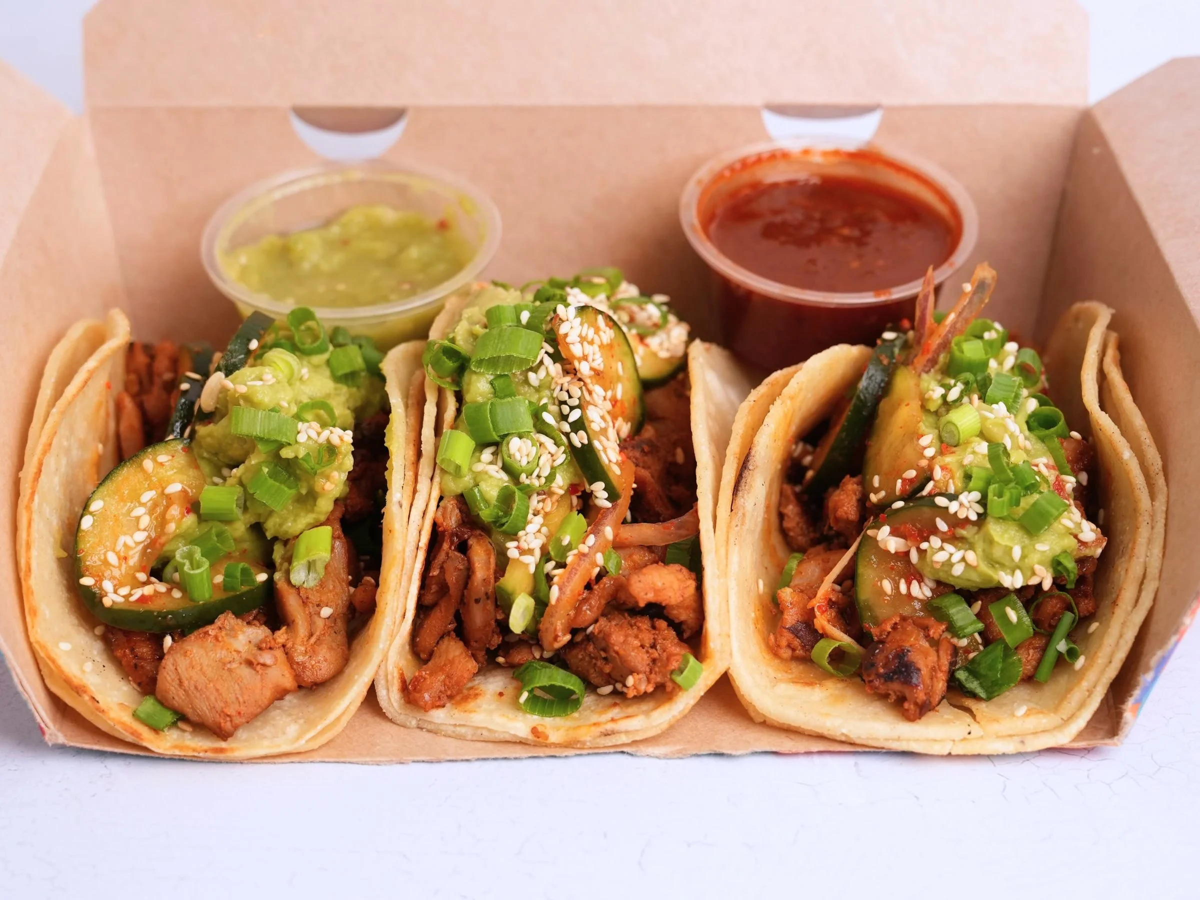 korean tacos topped with fresh guacamole