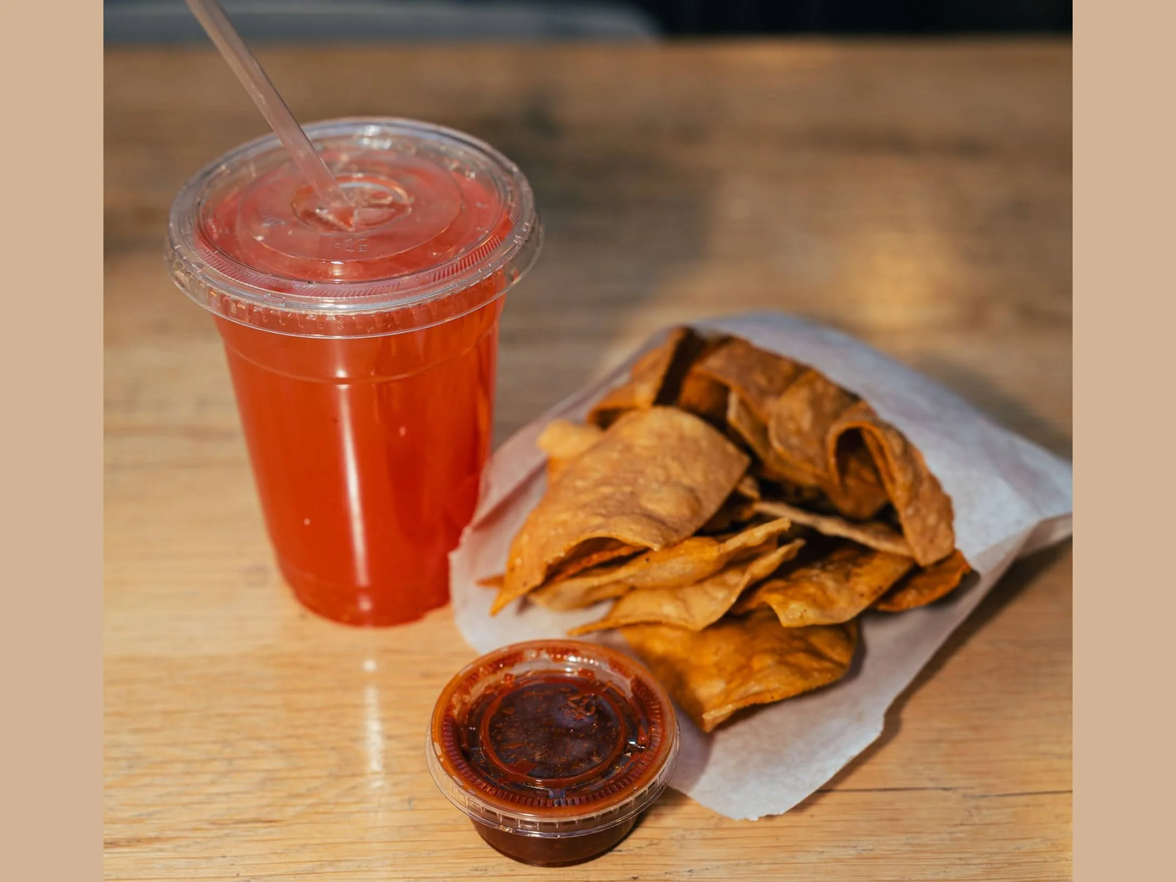 meal deal with tortilla chips salsa and a watermelon agua fresca