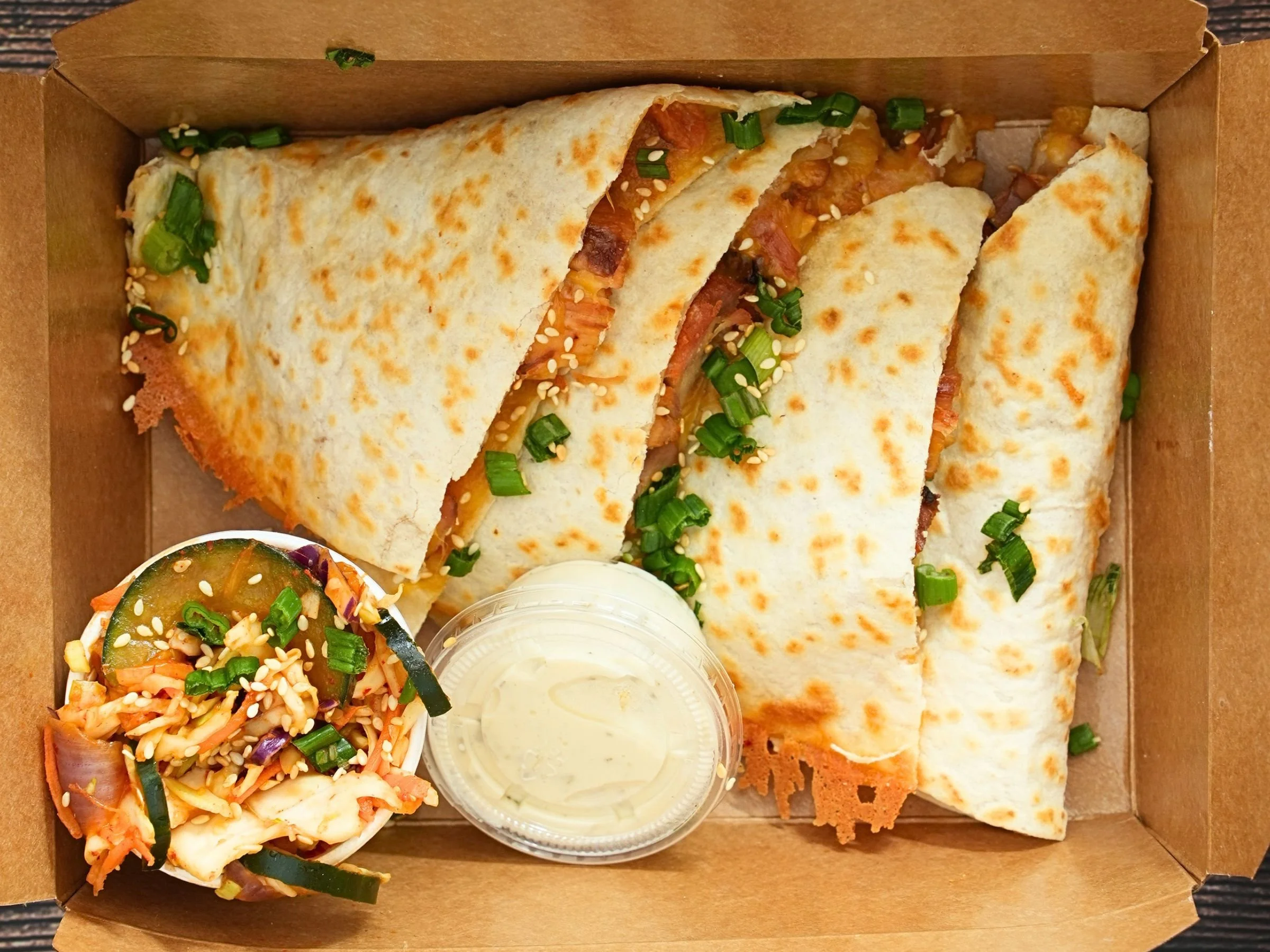 Korean fusion quesadilla with melted cheese scallions and sesame seeds