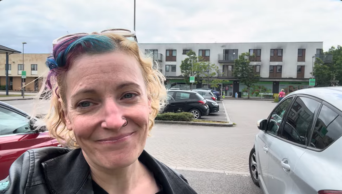 A woman standing in a car park