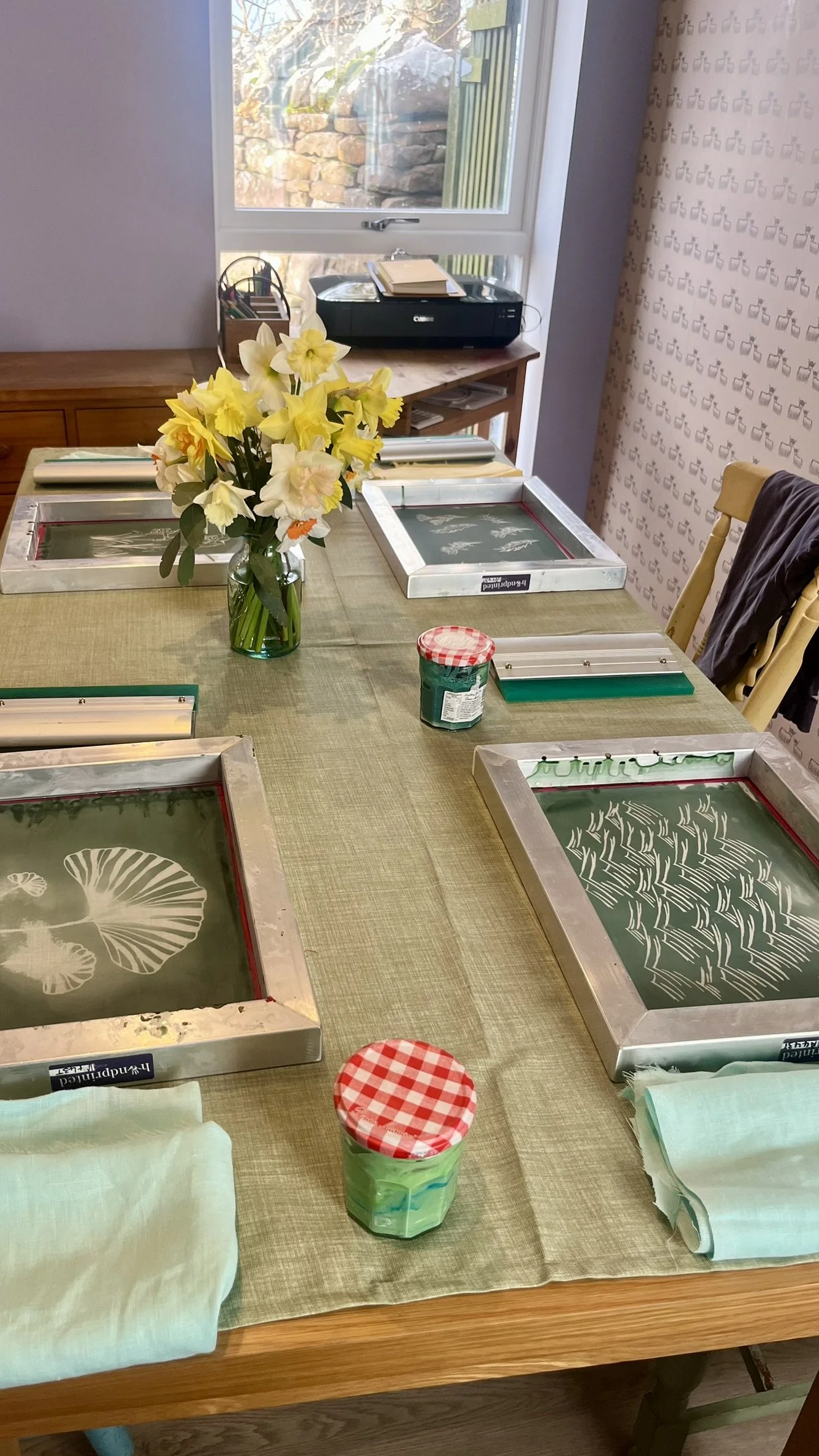 A Spring screen-printing workshop set-up in front of a bright window. 
