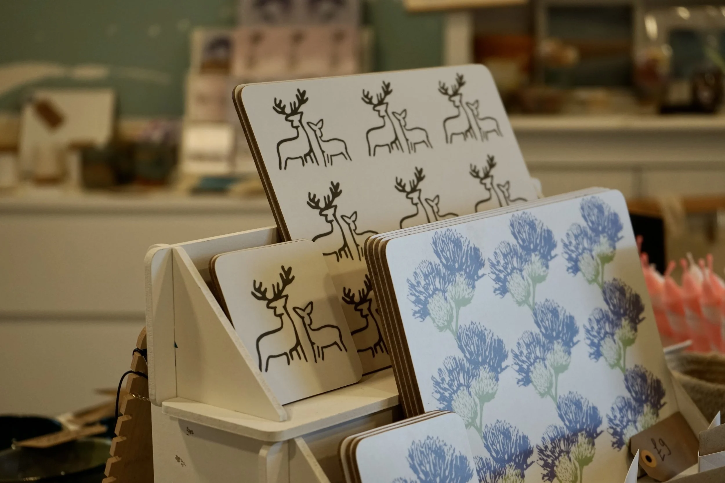 Display of Clement Design placemats in both Deer and Thistle prints.