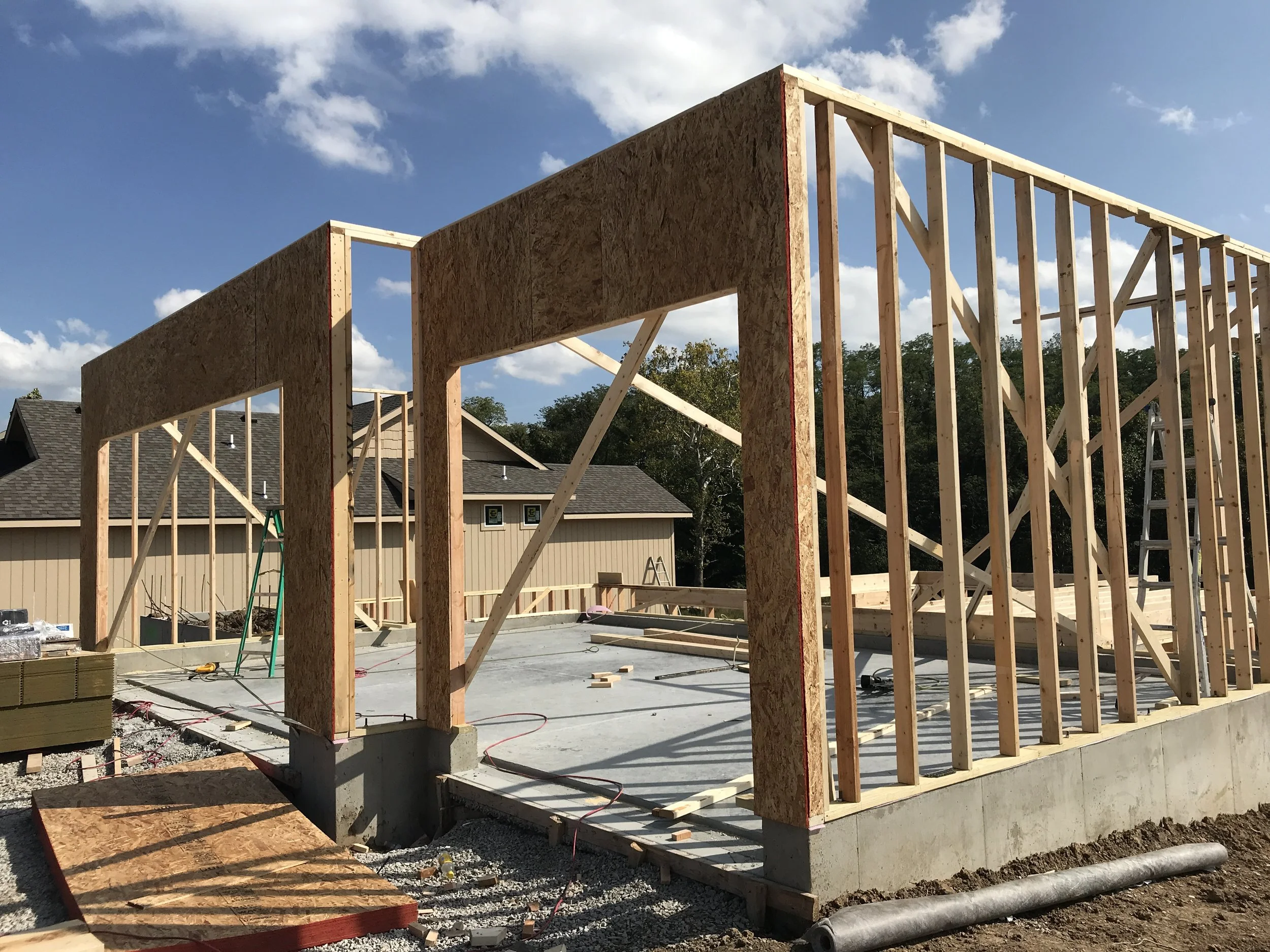 Custom home under construction in Kansas City showing wall framing and foundation work by Aspen Homebuilders