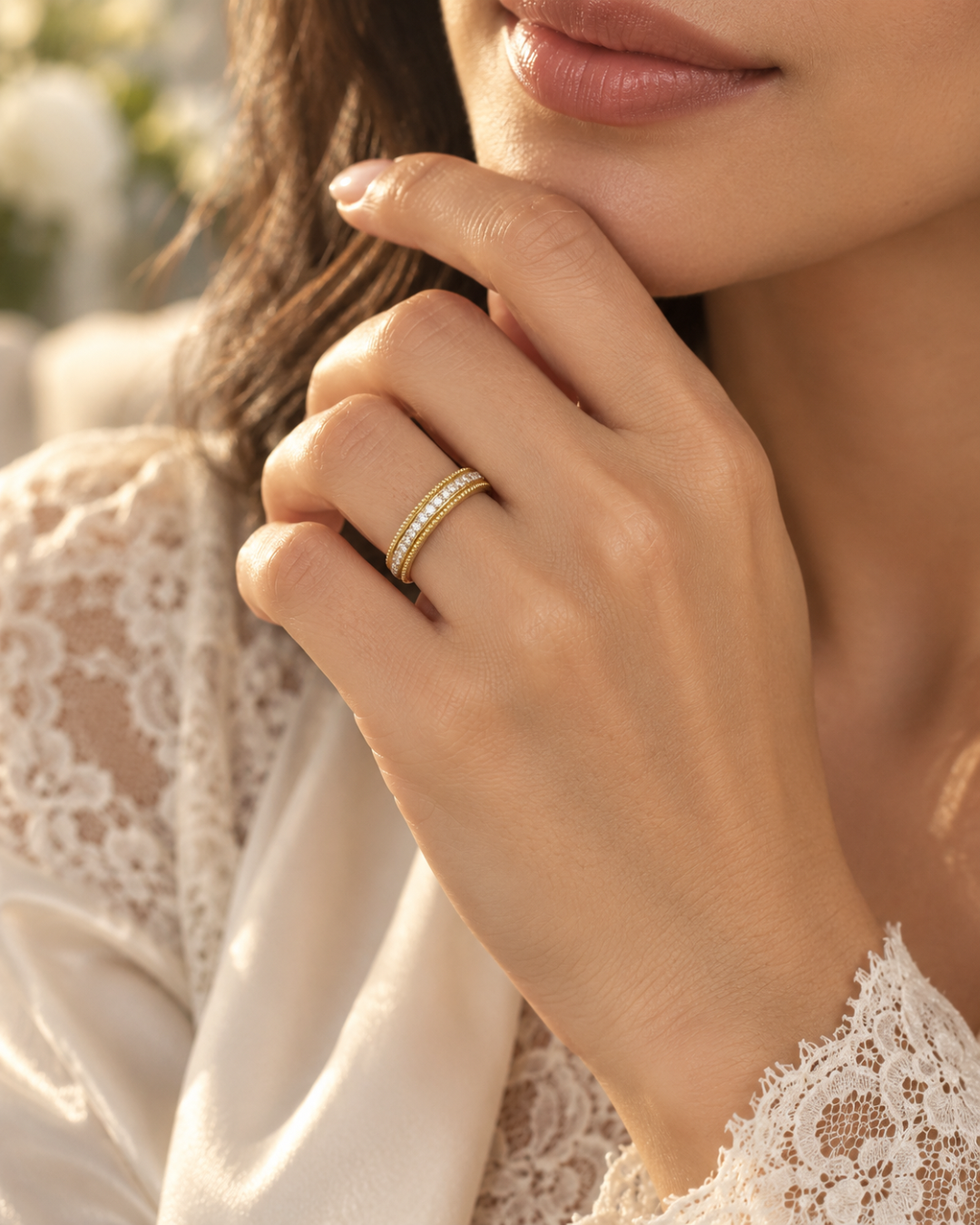 Handmade 18k gold diamond eternity ring with fine granulation, worn on the hand.