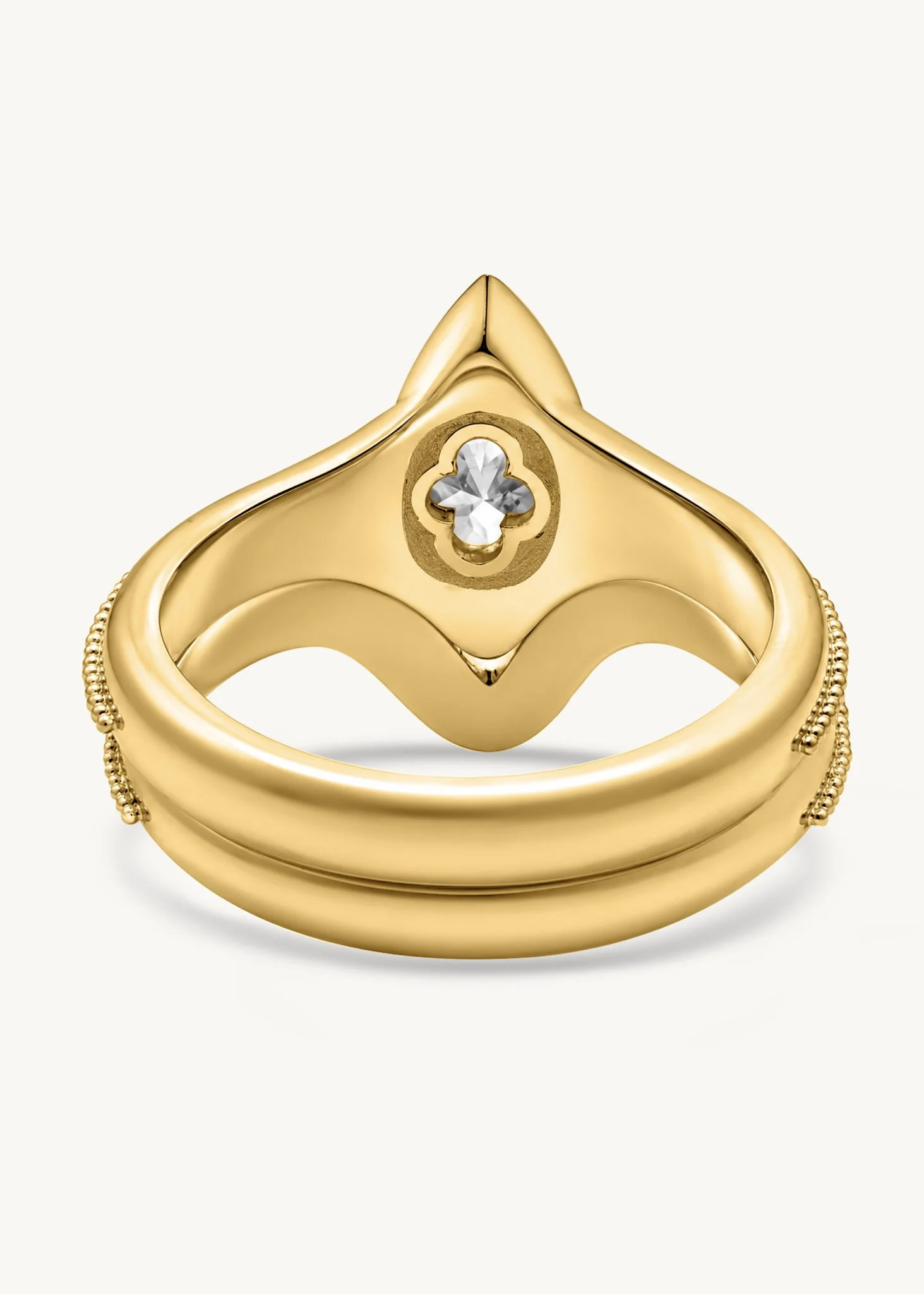 Underside of handmade 18k gold Signature Marquise Solitaire showing the quatrefoil oculus and sculpted setting.