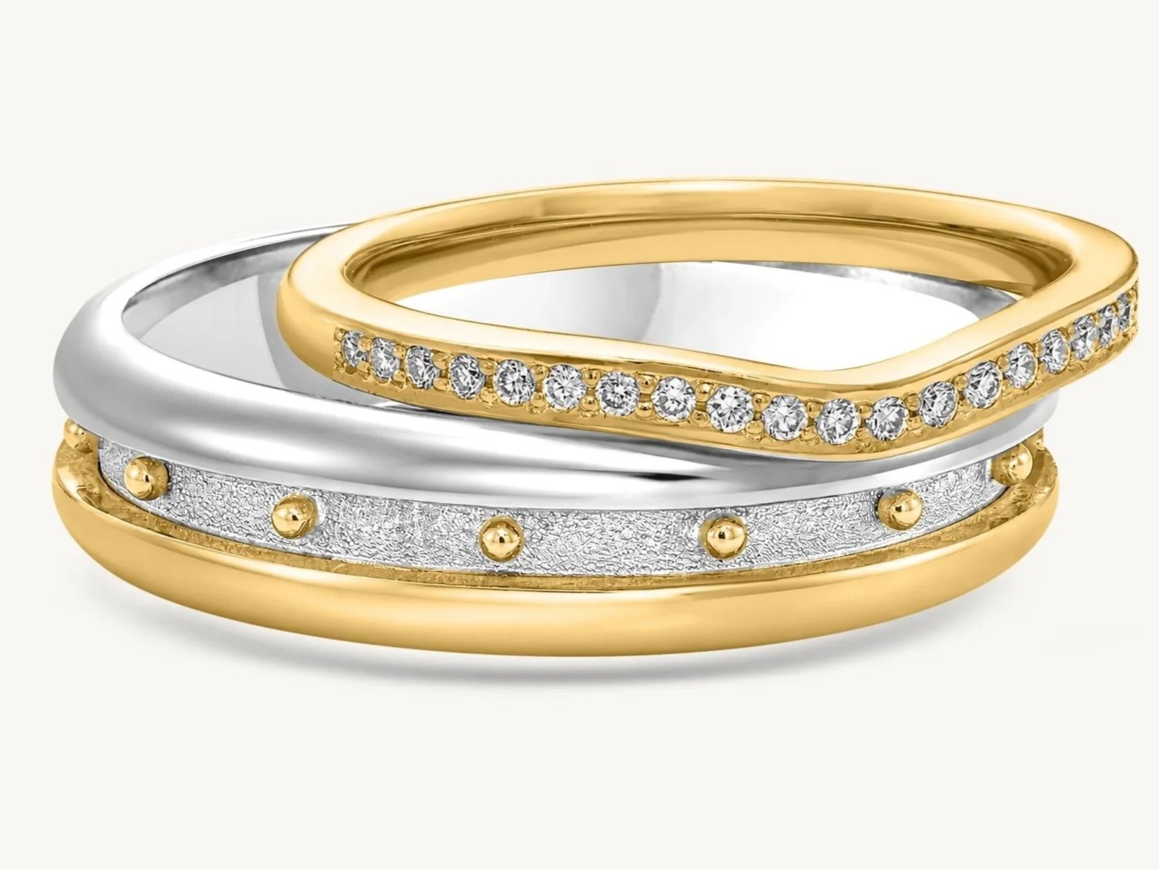 Stacked handcrafted gold and white-gold rings with diamond details and signature granulation by Rings by NK.