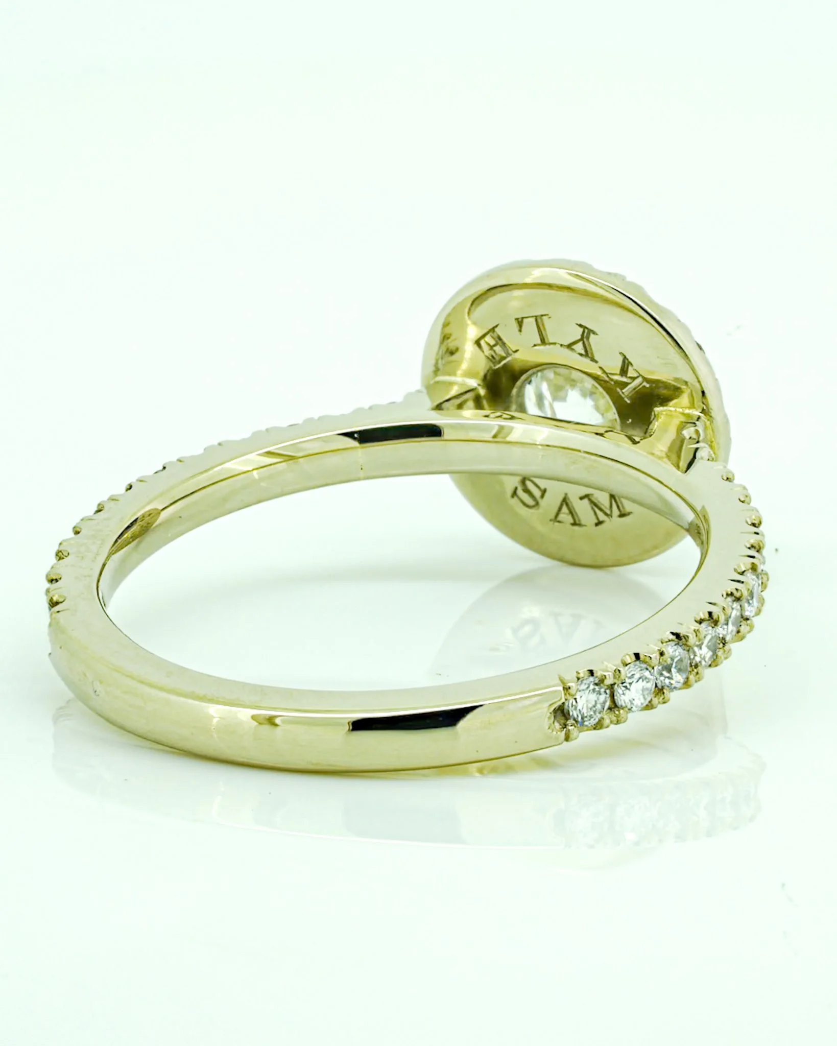 Side view of handmade 14k palladium white gold engagement ring showing the setting, band and granulated gold detailing