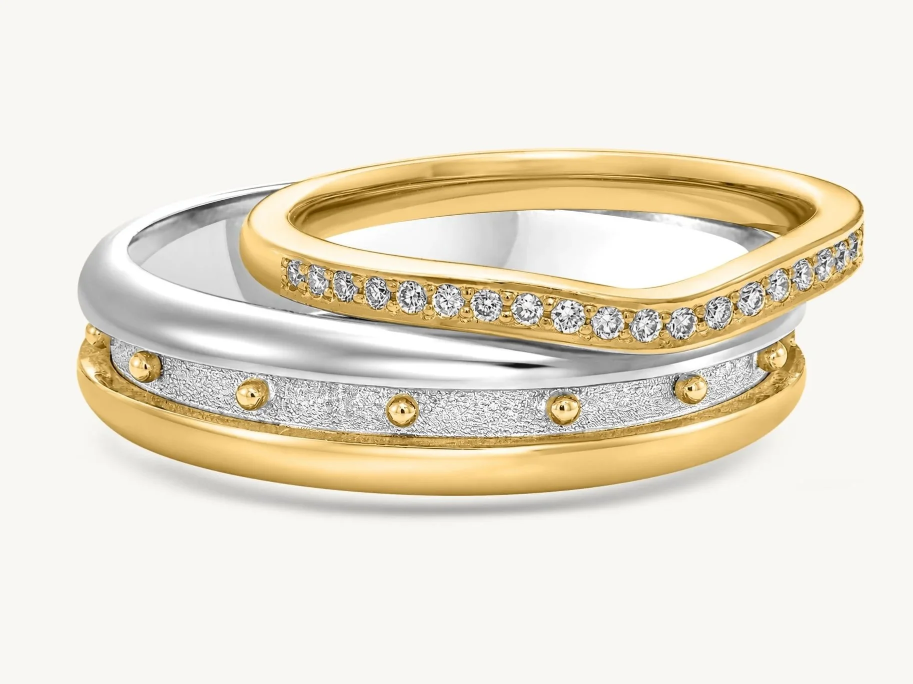 Handmade gold ring featuring diamond details and rows of traditional granulation along the edges.