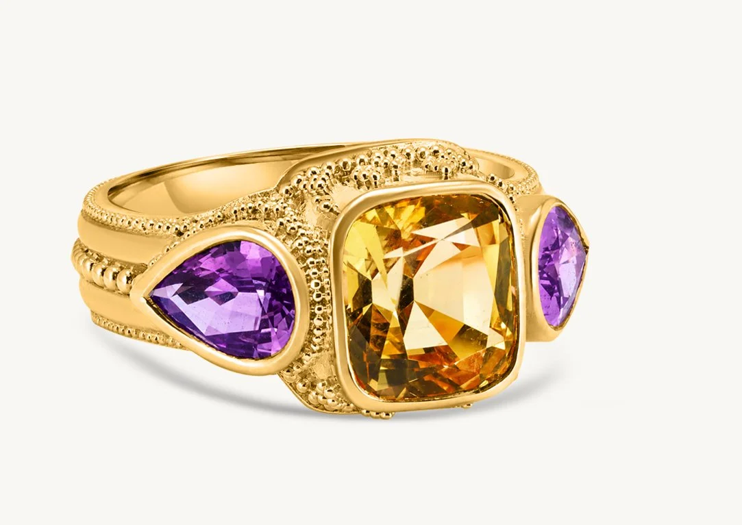 Front view of an 18k gold imperial topaz and pink sapphire ring framed with individually fused gold granules.