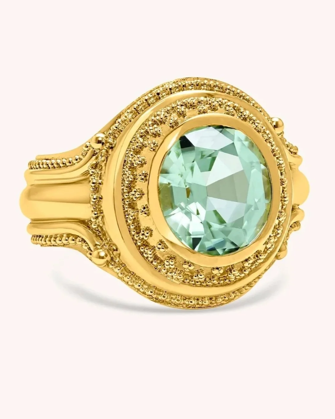 Handmade 18k gold cocktail ring with extensive surface granulation surrounding a natural mint tourmaline gemstone.