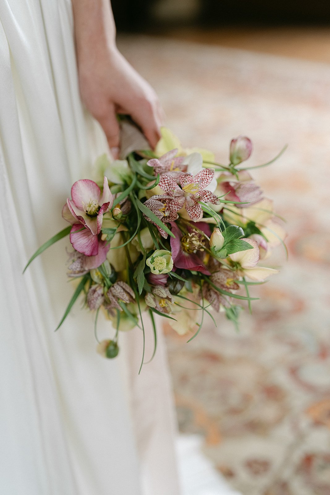 Bouquet of pink and purple flowers with greenery