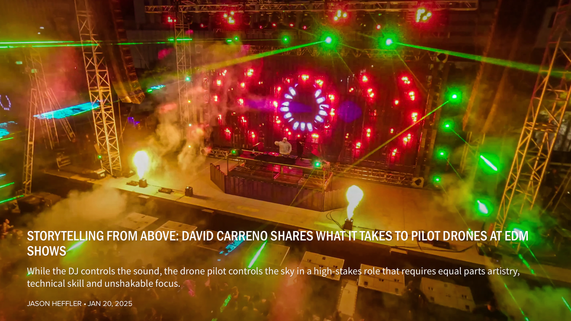 Overhead view of a DJ on stage at an EDM concert with colorful lights, lasers, and smoke effects, featuring a large circular light display behind the DJ and illuminated scaffolding.