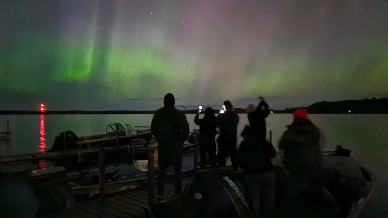 Guests at Timber Trail Lodge watching the Northern Lights over White Iron Lake near Ely, Minnesota.