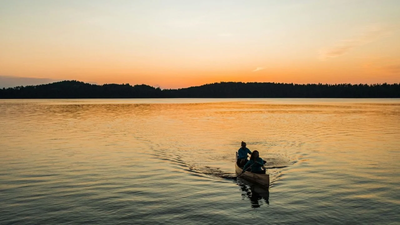 Two people boating on a lake in the Boundary Waters.