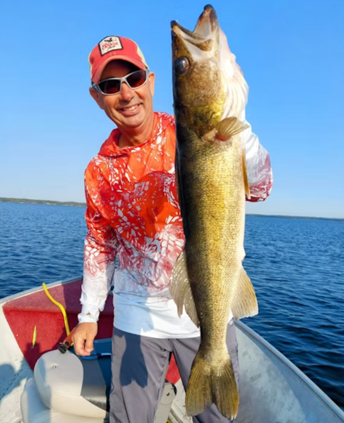 A man holding a large walleye.