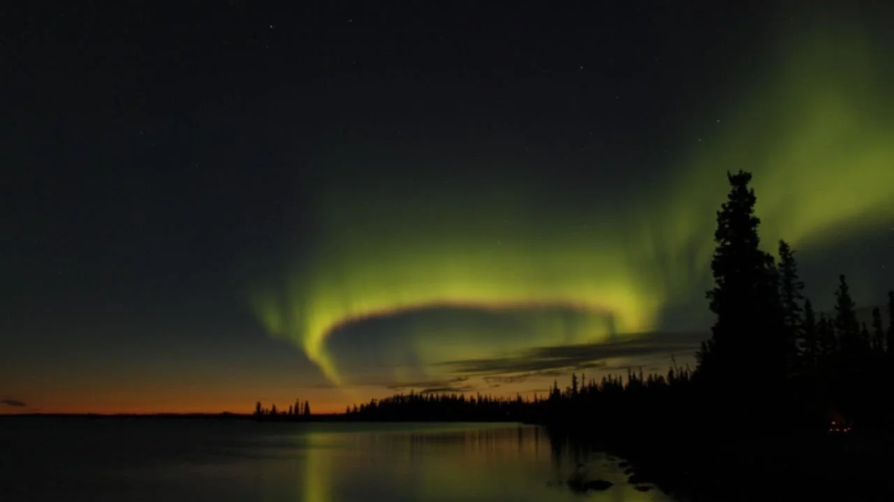 Aurora borealis over a lake at night.
