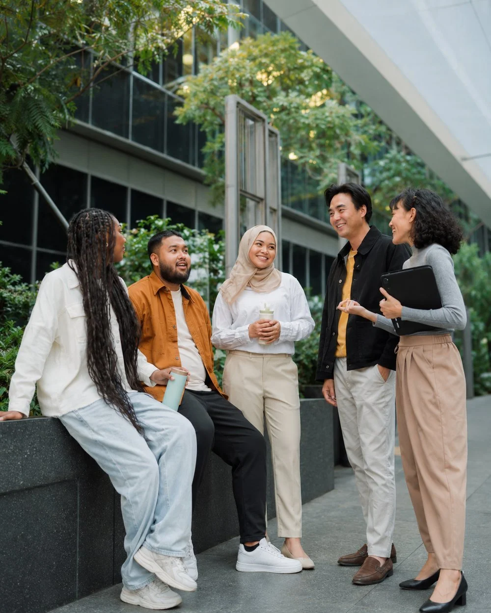 Diverse group of adults in conversation, representing the people I help through trauma-informed therapy in California and Virginia.