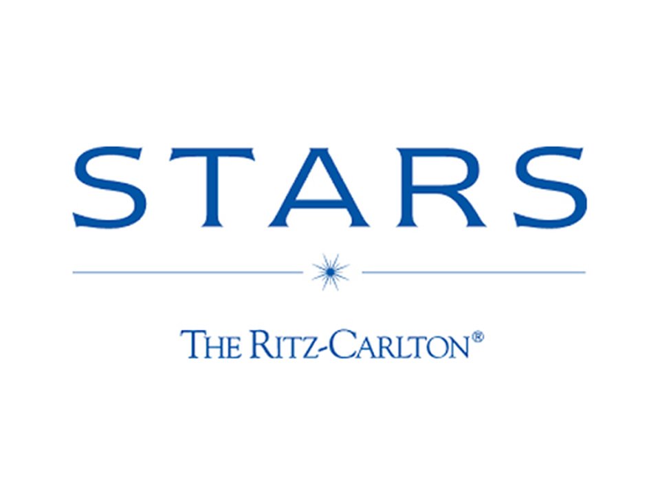 Logo featuring the word 'STARS' in blue text above 'The Ritz-Carlton' with a star symbol in between. The background is white.