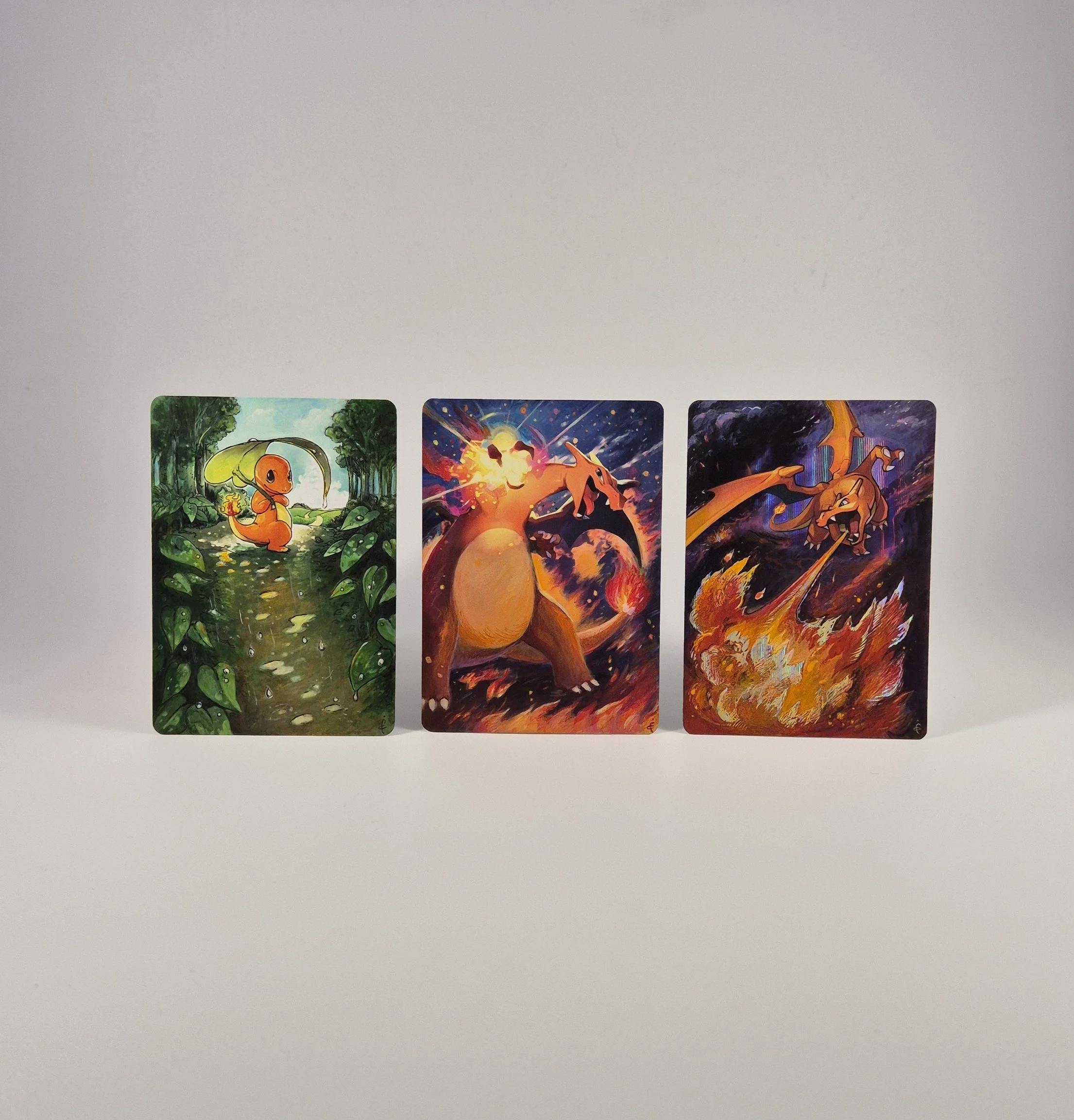 Two Charizard and one Charmander: three figures painted with acrylics for a collector commission.