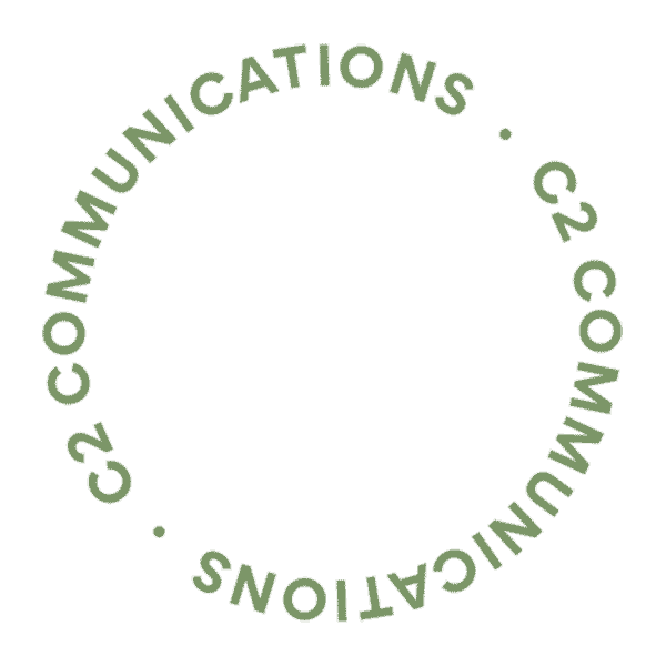 A circular, rotating line of text that says C2Communications